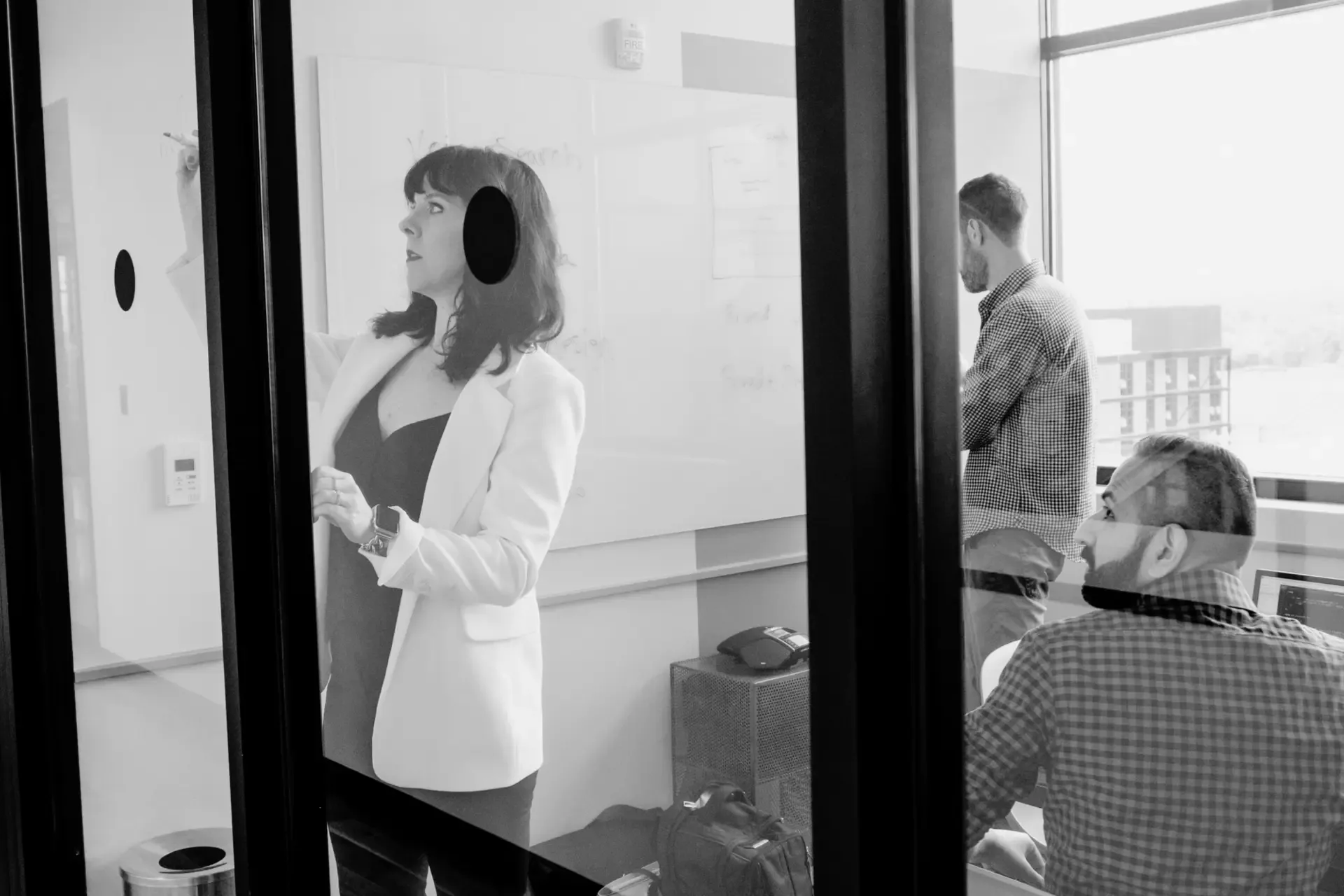 Working through a build plan on the whiteboard