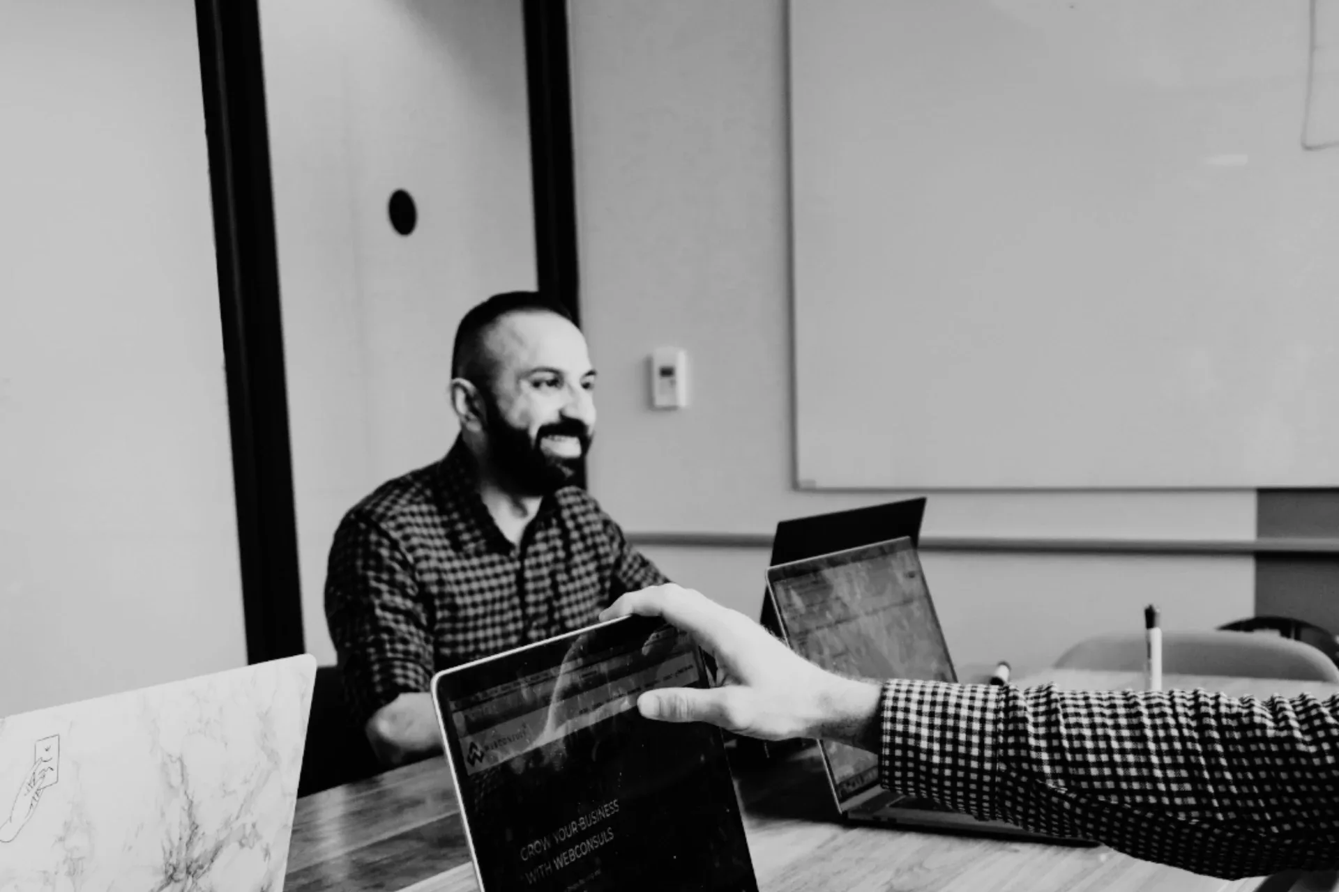 Webconsuls team member reviewing a website on a laptop